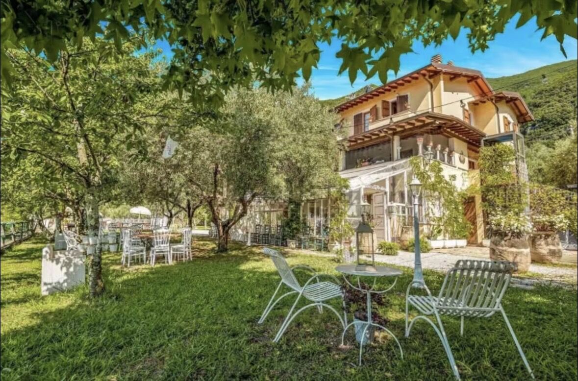 Villa garden with olive trees and outdoor seating