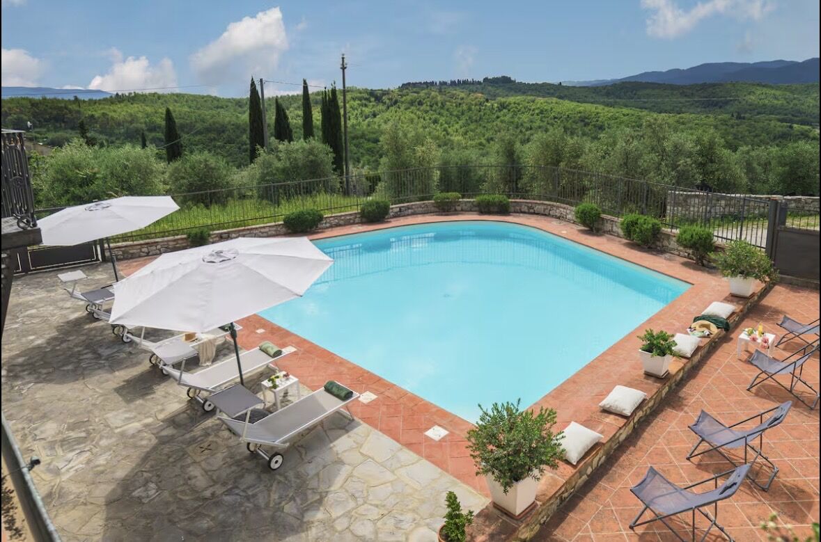 The villa pool surrounded by Tuscan hills