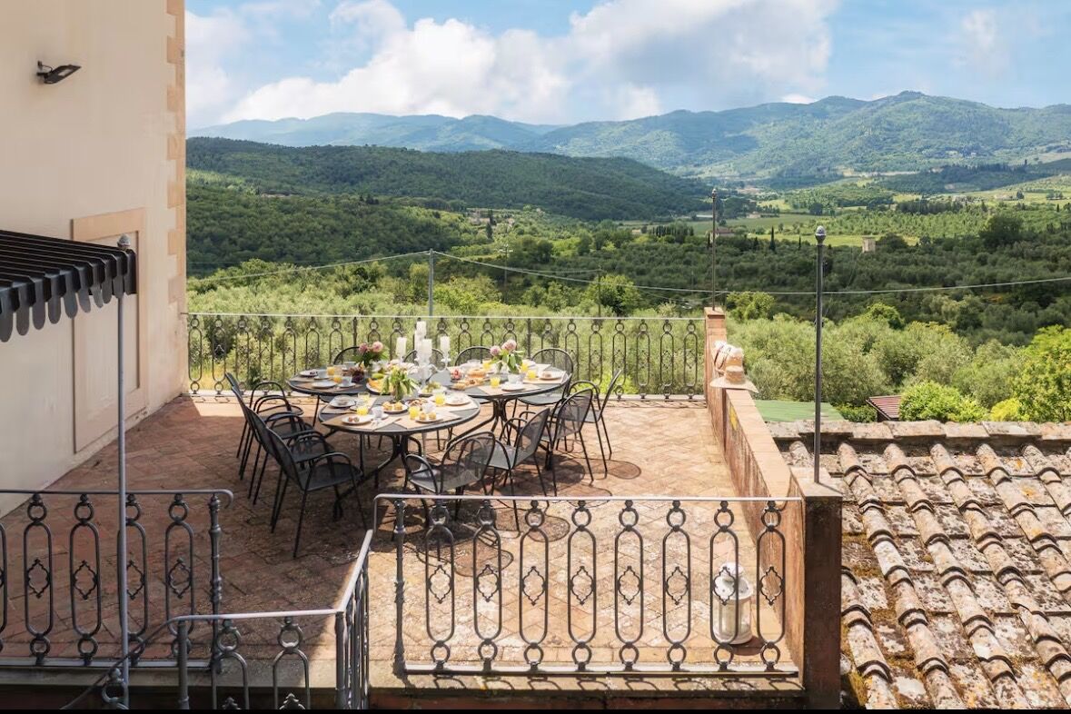 Breakfast table on the villa terrace overlooking the hills